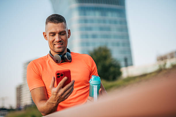istock Smiling sportsman using smartphone after training in the city 2234704316