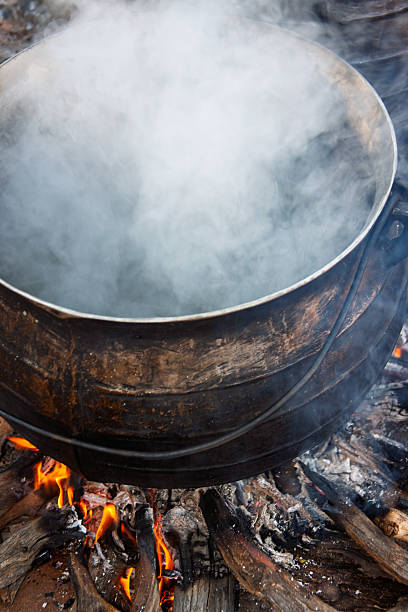 istock african traditional cooking outdoors in the open fire kitchen on cauldron three legged pot, boiling meat stew 2234705267