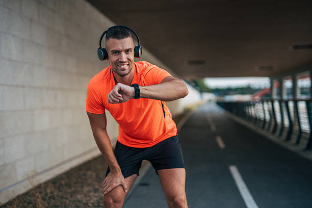 istock Young male athlete checking time during urban running session 2234705378