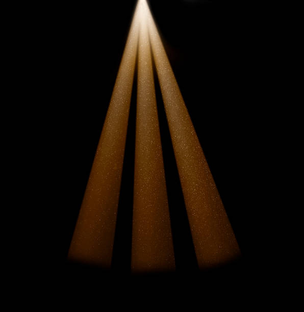 istock Three beams of light shining through dust particles in dark room 2234707948