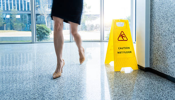 istock Caution wet floor sign with motion blurred legs walking 2234708360