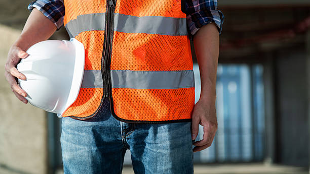 istock Close up of male construction worker holding white hardhat 2234708446