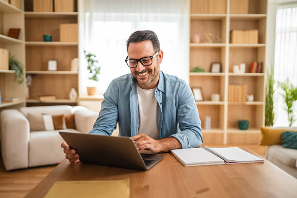 istock smiling freelancer enjoy while work on laptop from modern living room 2234710582