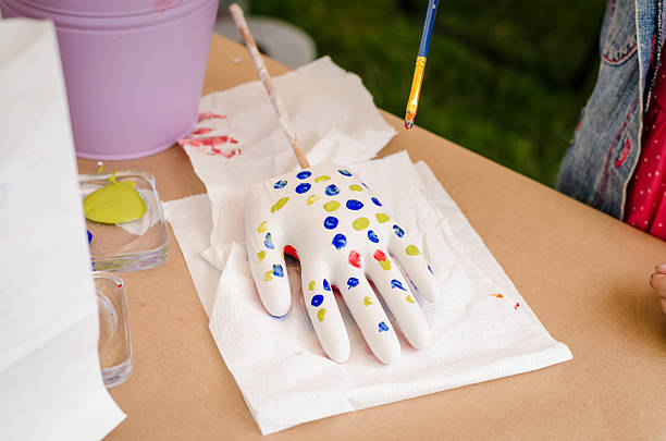 istock gypsum glowes  being painted 2234711734