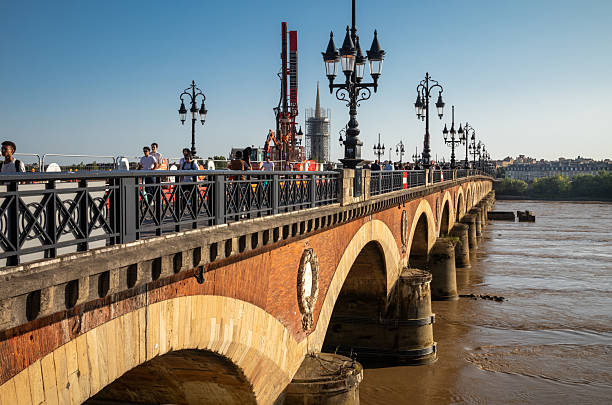 Pont de Pierre, an iconic 19th-century stone bridge commissioned by Napoleon and inaugurated in 1822, Bordeaux, France. It spans the Garonne river to to link the city's historic centre and the Bastide district.