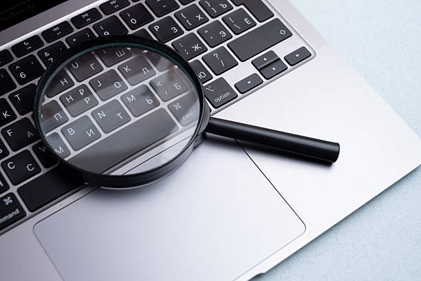 istock Magnifying glass on a laptop. Conceptual research, enlarging objects. Copy space for text. 2234714945