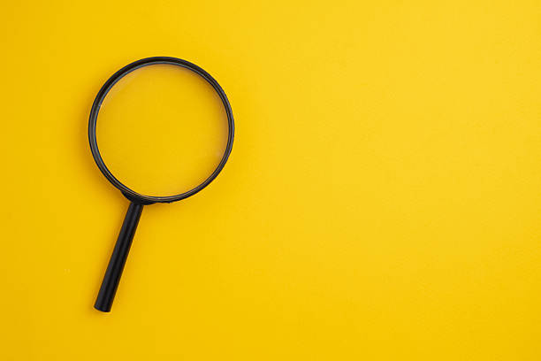 istock Magnifying glass on a colored background. Conceptual research, enlarging objects. Copy space for text. 2234715053