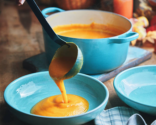 Preparing Butternut Pumpkin Soup with Cream and Roasted Pumpkin Seeds