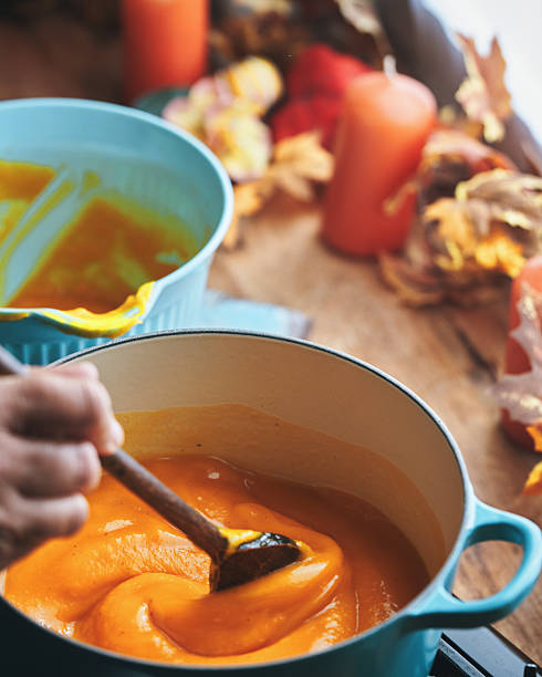 Preparing Butternut Pumpkin Soup with Cream and Roasted Pumpkin Seeds