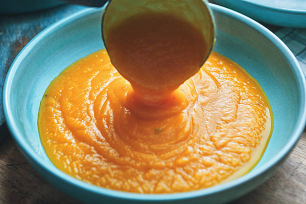Preparing Butternut Pumpkin Soup with Cream and Roasted Pumpkin Seeds