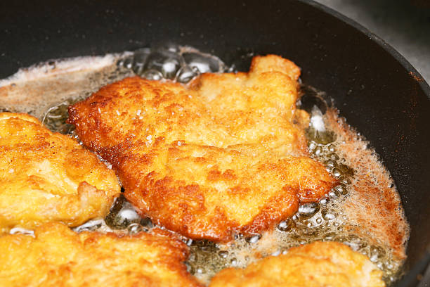 istock Fried chicken cutlet in pan. Golden crispy schnitzel. Hot oil cooking process. 2234717969