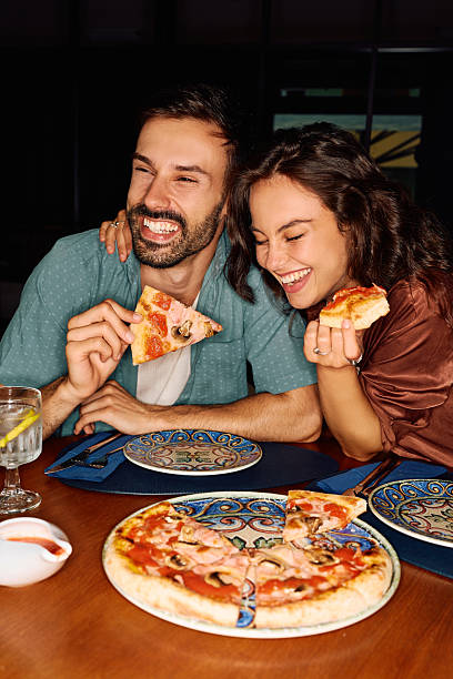 istock Cheerful couple having fun on a date in pizzeria. 2234718490