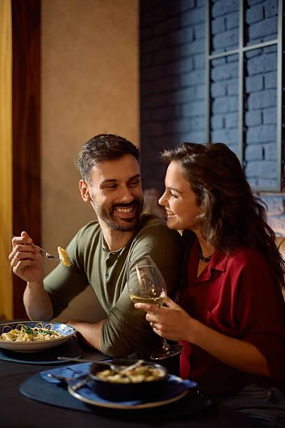 istock Young happy couple enjoying in lunch in a restaurant. 2234720247