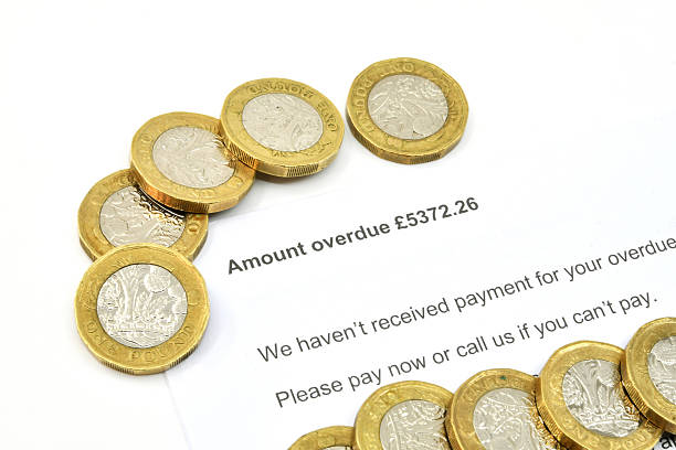 istock Official letter for overdue payment with one pound coins 2234720354