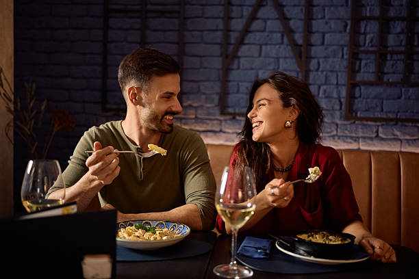 istock Happy couple communicating while eating in restaurant. 2234720386
