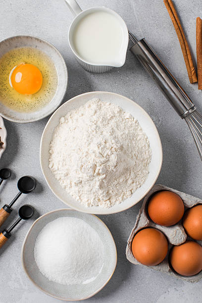 istock Baking ingredients flat lay with flour, eggs, sugar, and spices on marble surface 2234722282