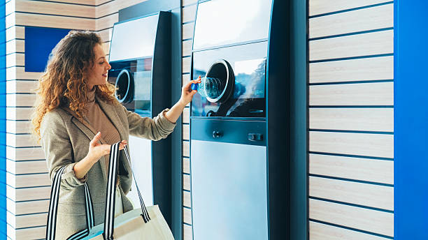 istock Woman recycling plastic bottle via reverse vending machine 2234725244