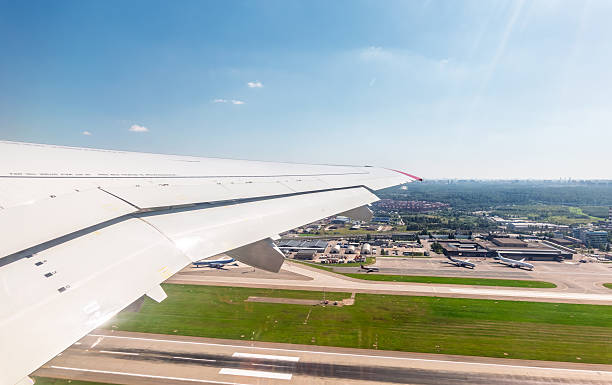 View from the airplane window during takeoff at Sheremetyevo airport at summer. Moscow, Russia