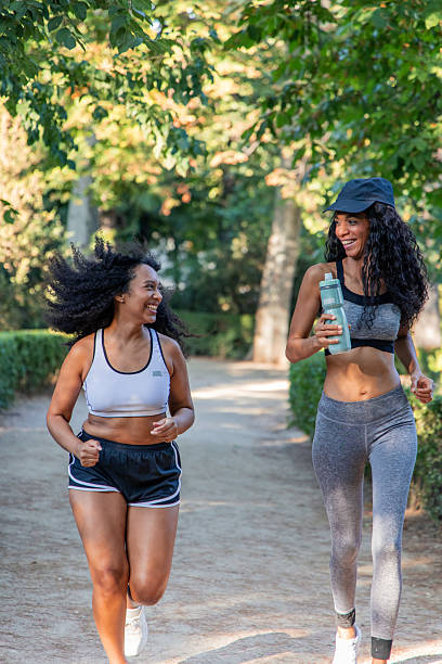 istock Two happy latin women running outdoors in a park 2234726200