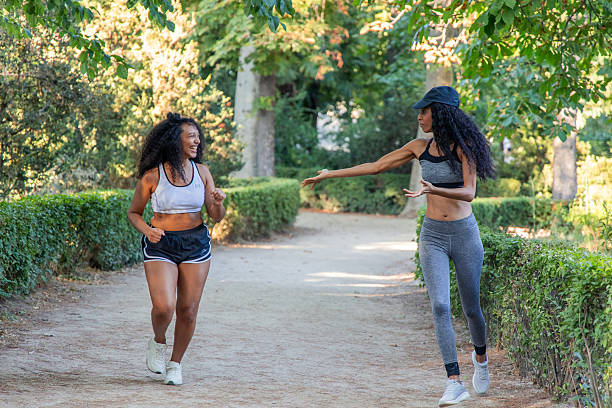 istock Two young latin women running outdoors in a park 2234726230