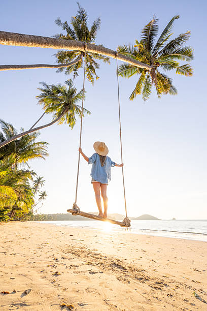 istock Woman Enjoying Swing on Tropical Beach 2234730280