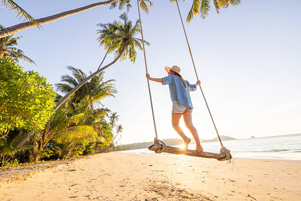 istock Woman Enjoying Swing on Tropical Beach 2234730281