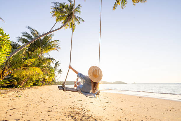 istock Woman Relaxing on Beach Swing at Sunset 2234730408