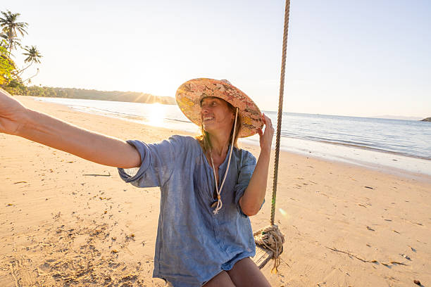 istock Woman Taking Selfie on Tropical Beach at Sunset 2234730564