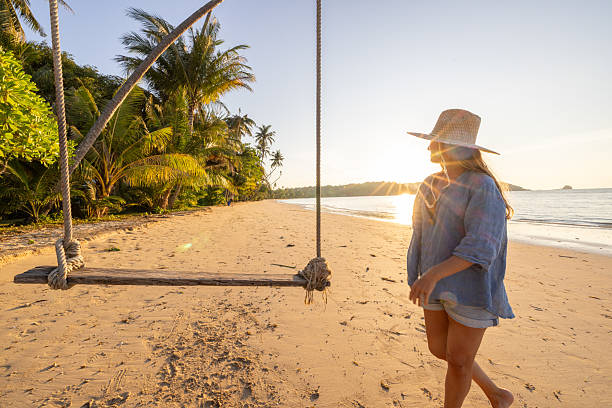 istock Woman Walking Alone on Tropical Beach at Sunset 2234730637