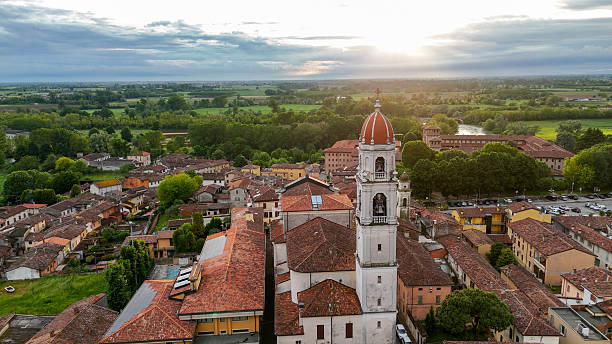 istock Pontevico landscape from above, church spire rising over terracotta rooftops, verdant surroundings, Oglio River winding through Brescia countryside at golden hour 2234731834