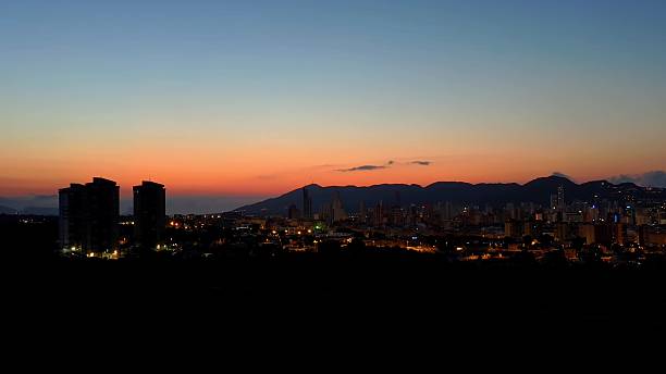 istock A stunning sunset casts vibrant colors over the cityscape with majestic mountains behind 2234732965