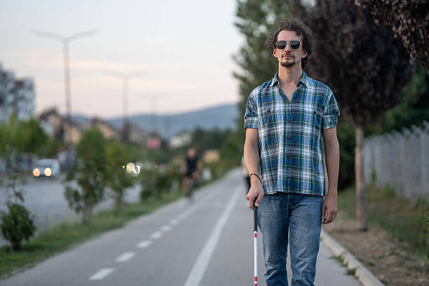 istock Blind Man with a Cane Walking on a City Pathway 2234733307