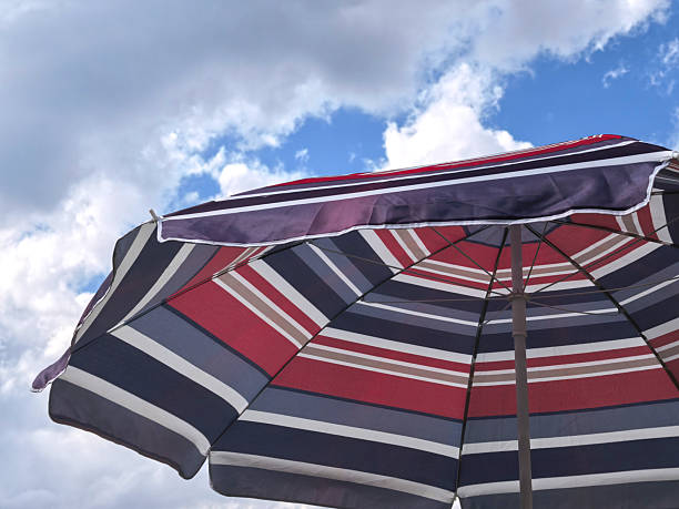 Colorful umbrellas on sandy beach facing the ocean shore