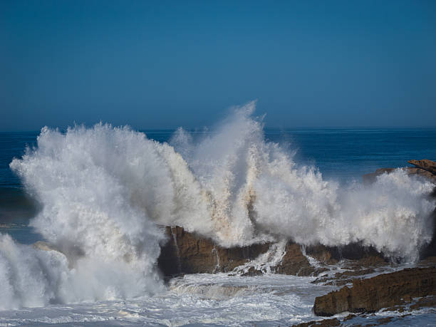 istock Huge ocean wave crashes against cliff, sending enormous splash high into air 2234738000