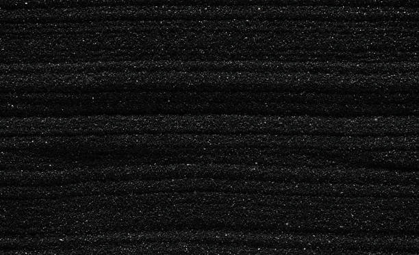 istock Dark black sand. Stripes and ripples of smooth volcanic sand texture or wallpaper. Wave pattern in black sand background. 2234740342