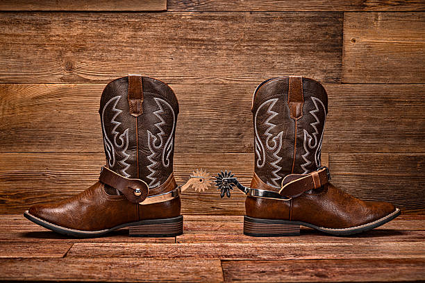istock Cowboy Boots with Spurs on Rustic Wooden Background with Copy Space 2234741734