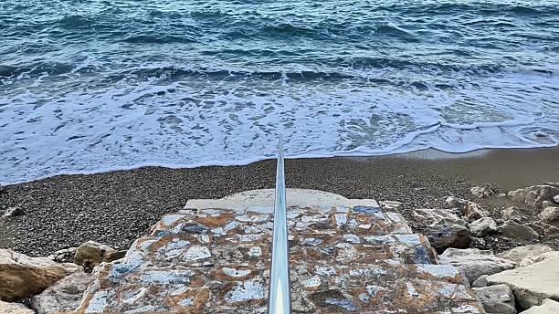 A seaside view with waves crashing against a stone jetty, capturing natures essence