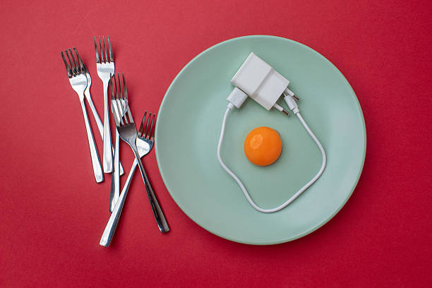 Egg made of raw yolk and white cable, forks on a plate with a red background. Flat lay. Modernism concept.