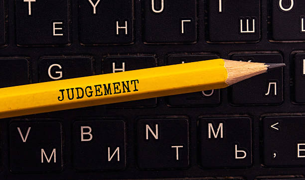 istock judgement word written on wood block. judgement text on table, concept 2234745396