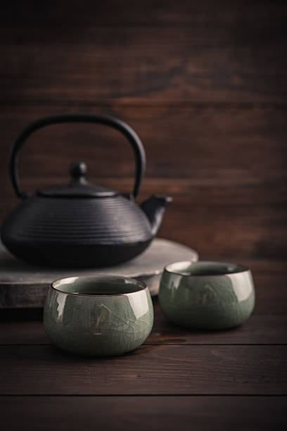 istock Cast iron black teapot and two bowls of tea 2234746292