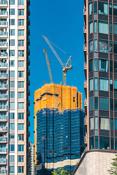 istock Cranes working on a new skyscraper in hong kong, china 2234747778