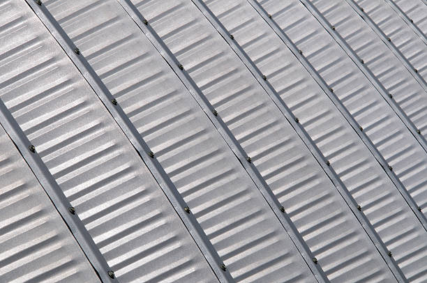 A close-up, full frame photograph of the steel ribs of a quonset hut