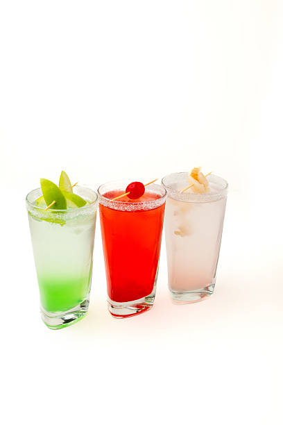istock Colorful cocktails with fruit garnish on white background – refreshing summer drinks for party and celebration 2234754844
