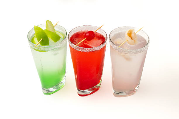 istock Colorful cocktails with fruit garnish on white background – refreshing summer drinks for party and celebration 2234754850