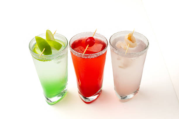 istock Colorful cocktails with fruit garnish on white background – refreshing summer drinks for party and celebration 2234754856