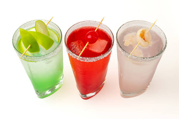 istock Colorful cocktails with fruit garnish on white background – refreshing summer drinks for party and celebration 2234754869