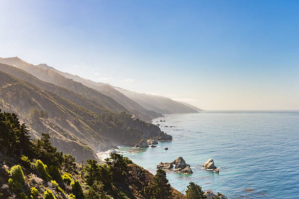 This is a photograph of a view of the Pacific Ocean with the coastal landscape by Big Sur California on a summer morning.