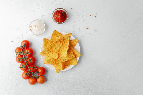 istock Crispy nachos with tomatoes, salsa and salt on white background 2234757179