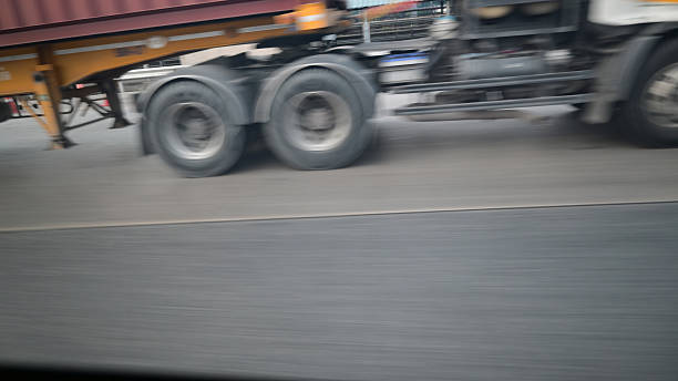 istock wheel of lorry on road, blurred image 2234772228