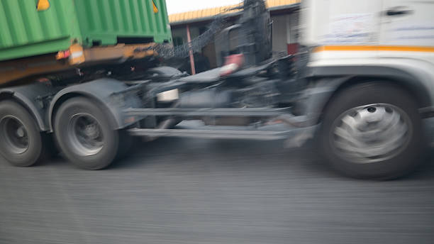 wheel of lorry on road, blurred image